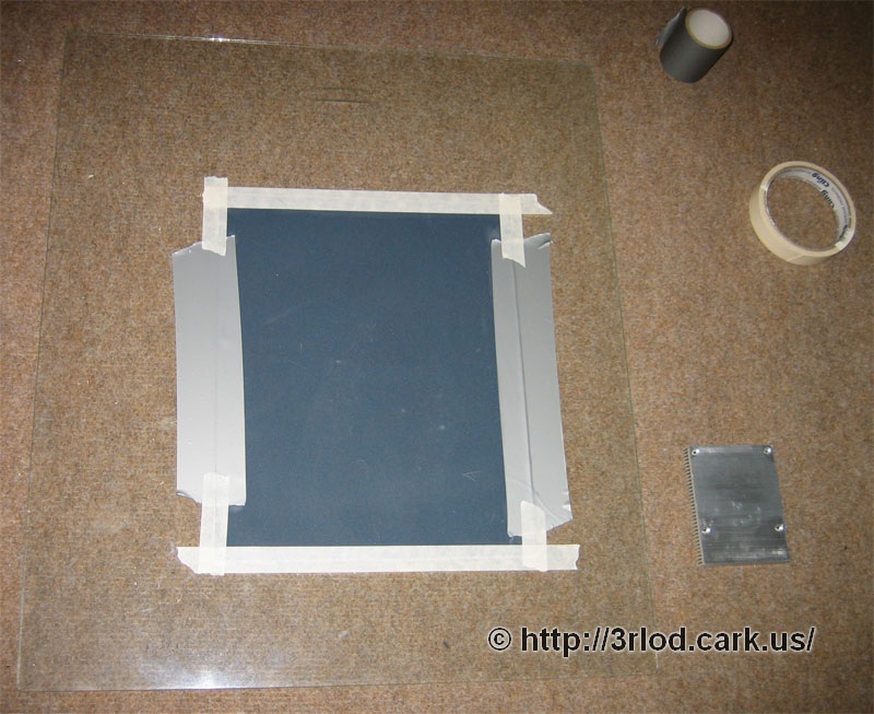 Glass sheet with sandpaper taped to the surface. Glass was used to ensure the surface was 100% flat.