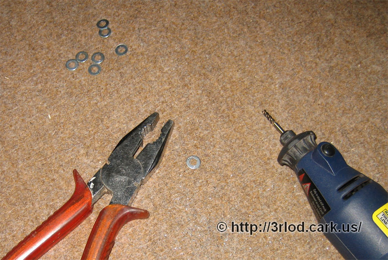 Rotary tool and metal washers that needed a slightly larger hole in the middle.