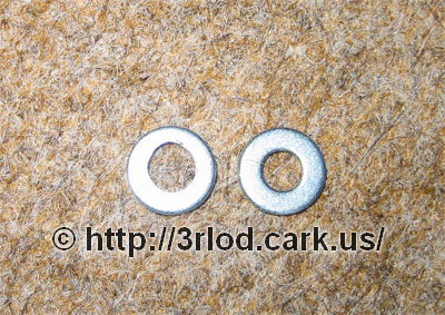 Close up of the metal washers after a bit of grinding. Washer on the left has a bigger hole now.
