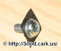 Bolt going through the metal washer, with electrical tape for insulation.