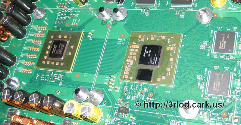 Top side of mainboard, with small flattened spring washer, then a metal washer on top.
