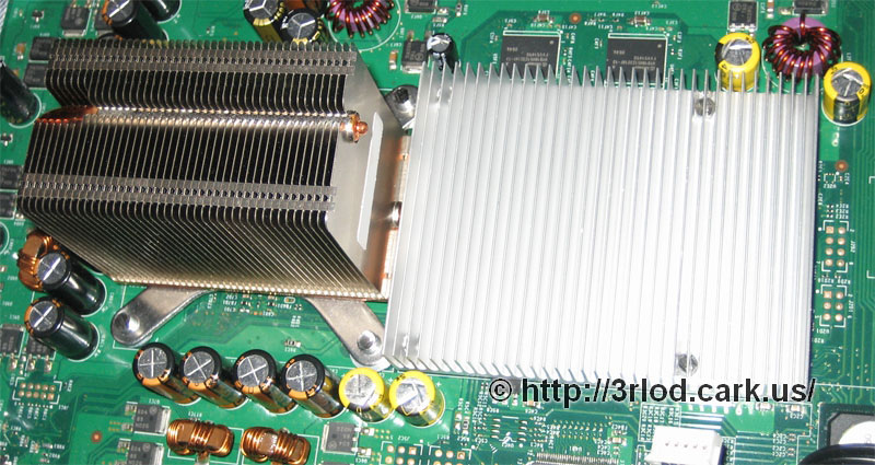 CPU and GPU heatsinks sitting on their respective chips. Bolts screwed into the original thread of the heatsinks.